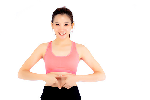 Beautiful portrait asian woman hand gesture heart shape on belly, girl wearing sport clothing with exercising isolated on white, healthy and diet concept.