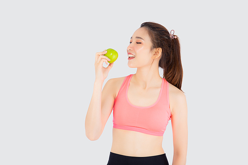 Beautiful portrait young asian woman in sport clothing with satisfied and eat green apple isolated on white, girl asia have shape and wellness, exercise for fit with health concept.