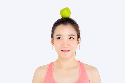 Beautiful portrait young asian woman in sport with satisfied and green apple on head isolated on white, girl asia have shape and wellness, exercise for fit with health concept.