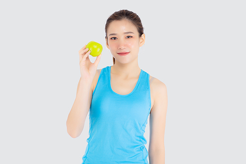 Beautiful portrait young asian woman in sport clothing with satisfied and holding green apple isolated on white, girl asia have shape and wellness, exercise for fit with health concept.