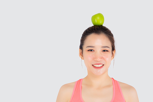 Beautiful portrait young asian woman in sport with satisfied and green apple on head isolated on white, girl asia have shape and wellness, exercise for fit with health concept.