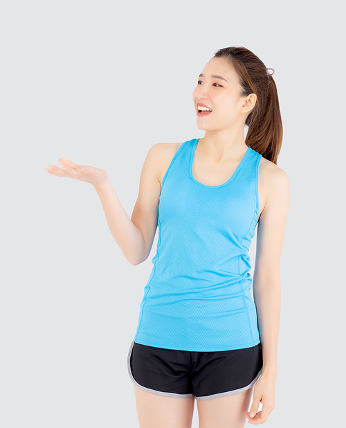 Beautiful portrait young asian woman in sport with satisfied and holding and throw green apple isolated on white, girl asia have shape and wellness, exercise for fit with health concept.