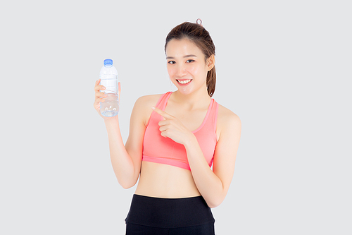Beautiful young asian woman in sport after workout drinking water for thirsty isolated on white, asia girl exercise pointing bottle of water for hydration and refresh with healthy.