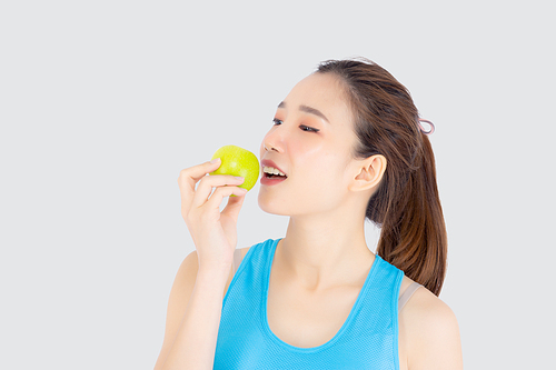 Beautiful portrait young asian woman in sport with satisfied and holding and eat green apple isolated on white, girl asia have shape and wellness, exercise for fit with health concept.