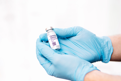 Coronavirus vaccine. Doctor with a vaccine. Hands holding a coronavirus vaccine ampoule, against Covid-19.