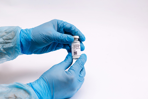 Coronavirus vaccine. Doctor with a vaccine. Hands holding a coronavirus vaccine ampoule, against Covid-19.