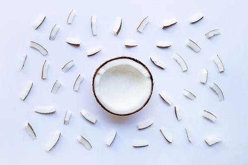 Half Coconut with coconut pieces on white background.
