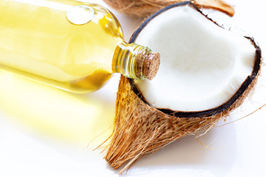 Coconut oil with coconuts on white background.