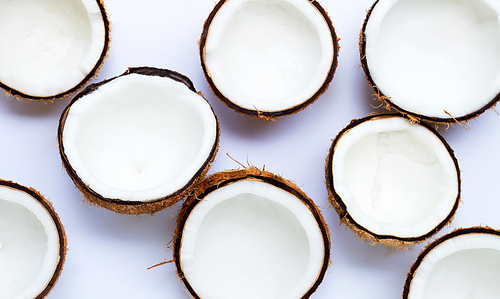 Half coconuts on white background. Top view