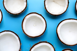 Half coconut on a blue background. Top view