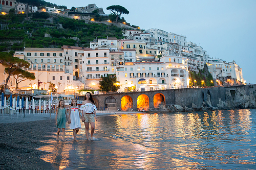 Mother and kids on vacation in Italy on Amalfi coast in evening light