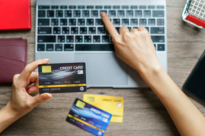 Woman hands holding and using cradit card for shopping online.