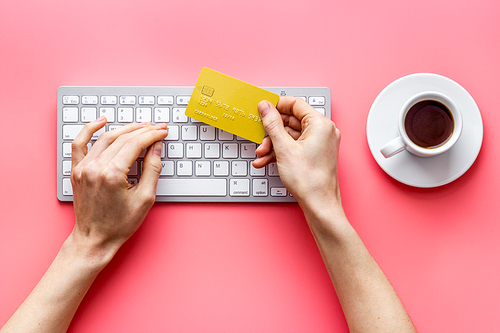 shopping online payment. Hand enter data on keyboard on desk top-down.