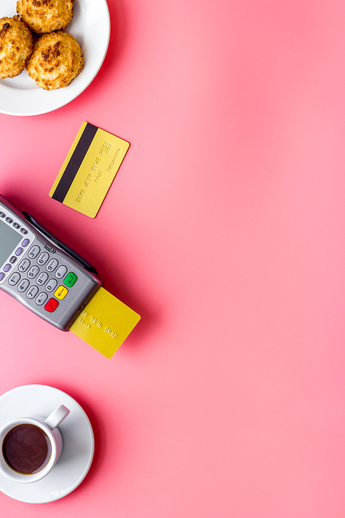 Payment by credit card. Terminal on restaurant desk from above.