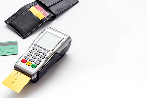 Payment by credit card. Terminal on white table.
