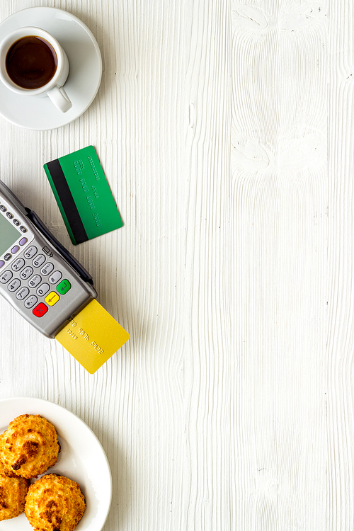 Payment by credit card. Terminal on restaurant desk from above.