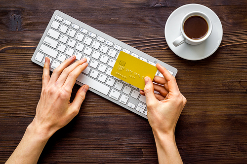 shopping online with credit card. Hand enter data on keyboard top view.