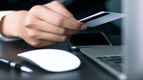 Online payment, use credit card instead of cash to buy online, male businessman holding credit card.