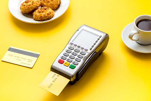 Payment transactions. Terminal and credit card on cafe wooden table.