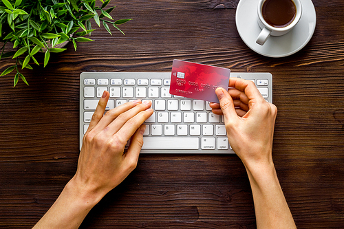 shopping online payment. Hand enter data on keyboard on desk top-down.