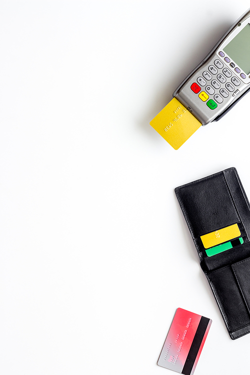 Payment by credit card. Terminal on white background top-down.