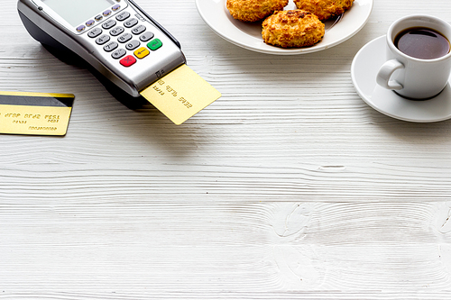 Payment transactions. Terminal and credit card on cafe white table.