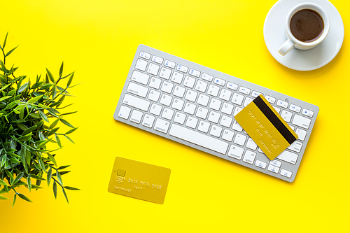 shopping online payment. Card on keyboard on desk top-down.