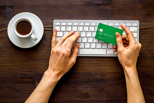 shopping online payment. Hand enter data on keyboard on desk top-down.