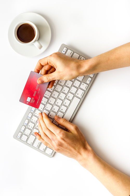 shopping online payment. Hand enter data on keyboard on desk top-down.