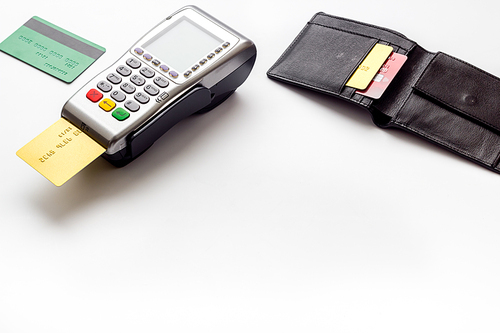 Payment by credit card. Terminal on white table.