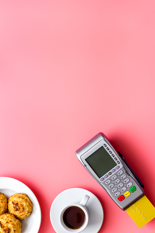 Payment by credit card. Terminal on restaurant desk from above.