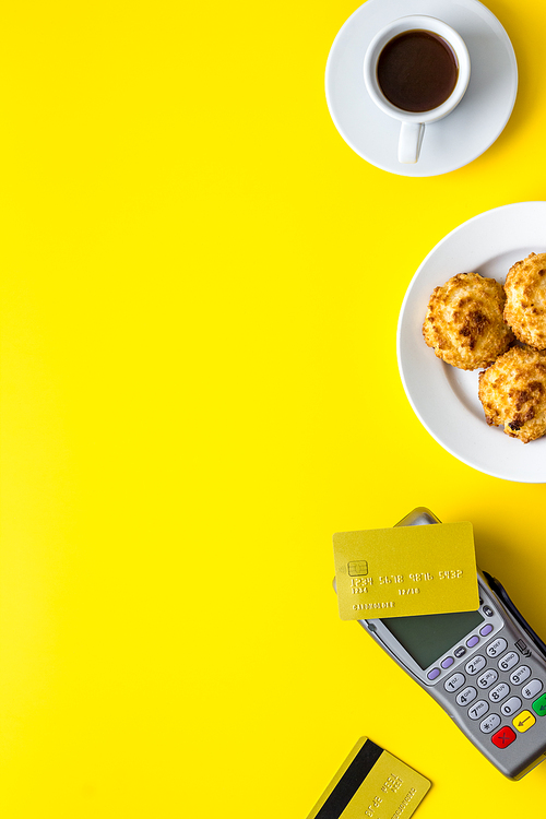 Payment by credit card. Terminal on restaurant desk from above.