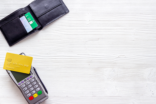 Payment by credit card. Terminal on white background top-down.