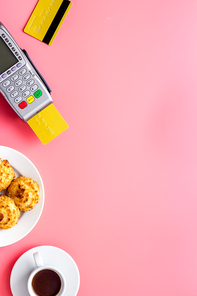 Payment by credit card. Terminal on restaurant desk from above.