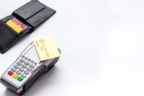 Payment by credit card. Terminal on white table.