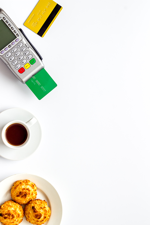 Payment by credit card. Terminal on restaurant desk from above.