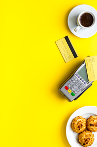 Payment by credit card. Terminal on restaurant desk from above.