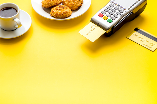 Payment transactions. Terminal and credit card on cafe wooden table.