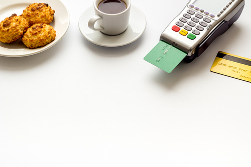 Payment transactions. Terminal and credit card on cafe white table.