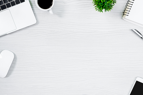 White wood office desk table and equipment for working with black coffee  in top view and flat ray concept.