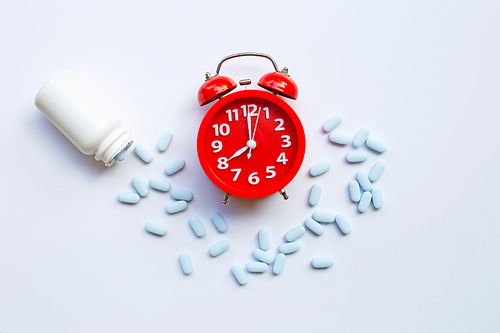 Red alarm clock ring with PrEP ( Pre-Exposure Prophylaxis). used to prevent HIV.