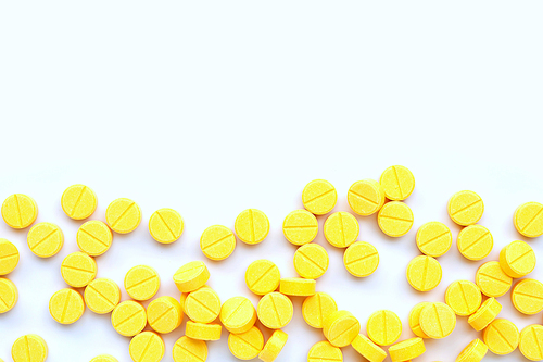 Tablets of Paracetamol on yellow background. Copy space