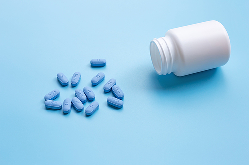 PrEP ( Pre-Exposure Prophylaxis) used to prevent HIV, on blue background, Copy space