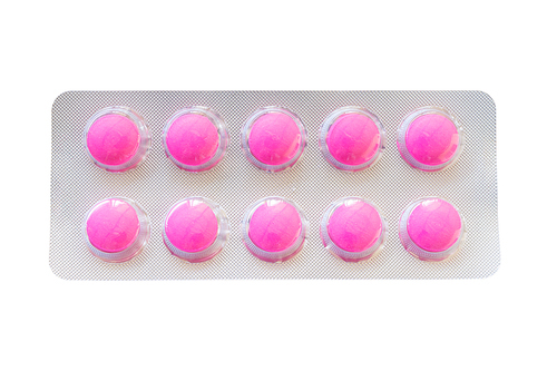 Pink pills in blister pack isolate on white with Clipping path