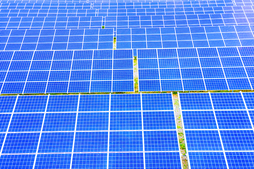 power solar panel on blue sky background,alternative clean green energy concept. Aerial view of Solar panels Photovoltaic systems industrial landscape