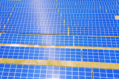 solar panels with the sunny sky. Blue solar panels. background of photovoltaic modules for renewable energy. Aerial view of Solar panels Photovoltaic systems industrial landscape