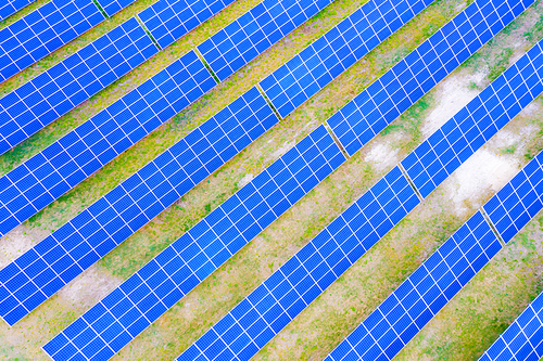 power solar panel on blue sky background,alternative clean green energy concept. Aerial view of Solar panels Photovoltaic systems industrial landscape