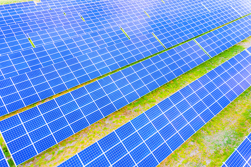 power solar panel on blue sky background,alternative clean green energy concept. Aerial view of Solar panels Photovoltaic systems industrial landscape