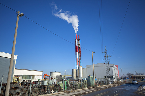 Heating plant - powerhouse and chimey with smoke make heat energy for city in winter