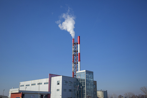 Heating plant - powerhouse and chimey with smoke make heat energy for city in winter